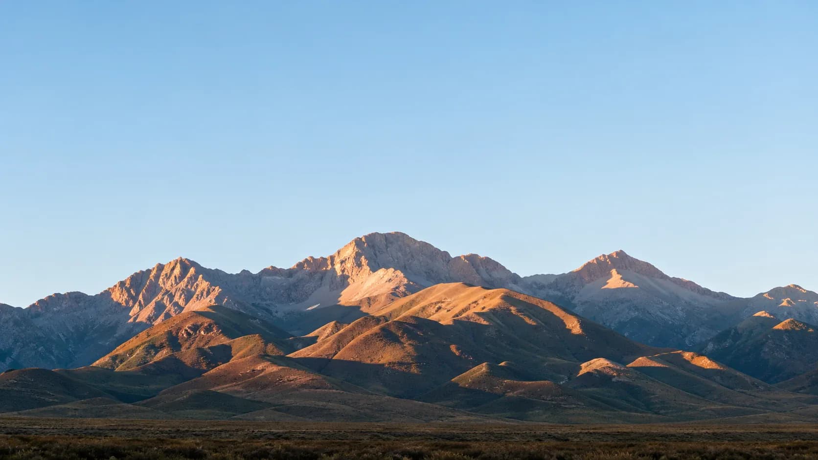 sunlit mountain peaks at dawn